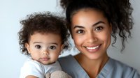 Young African American mother and baby boy sharing tender moment together against light background, genuine smiles and curly hair, wearing casual attire.