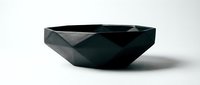 Black geometric faceted bowl with angular polygonal design on white background, isolated modern decorative ceramic dish for interior and product design use.