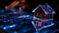 Glowing blue digital house hologram on dark background with light trails and reflections creating futuristic technology concept for smart home solutions.