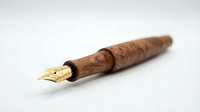 Elegant wooden fountain pen with gold nib isolated on white background for luxury writing instruments and stationery design projects.