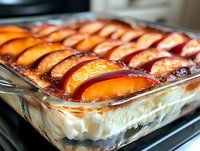 Baked custard dessert with caramelized apple slices arranged in rows on creamy filling, ready for serving or recipe inspiration.