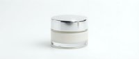 Luxury cosmetic cream jar with silver cap isolated on white background for skincare and beauty product packaging design.