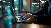 Professional businessman typing on laptop with digital network connections and glowing data particles in modern office environment at night.