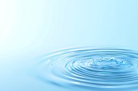 Concentric ripples expanding outward from water drop impact on calm blue surface, creating circular pattern of waves against soft aqua background.