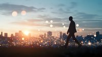Silhouette of businessman walking on hill against urban cityscape at sunset with bokeh light effects, representing success, leadership and future vision.