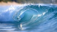 Powerful ocean wave curling with crystal clear blue water and white spray creating natural barrel shape, dramatic seascape captured in motion for surfing and nature designs.