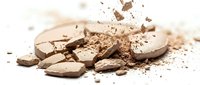 Broken chocolate pieces with cocoa powder scattered on white background, isolated for confectionery and dessert design projects.