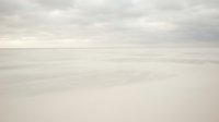 Serene minimalist seascape with calm ocean waters and soft cloudy sky in neutral tones creating peaceful atmospheric mood for meditation and relaxation.
