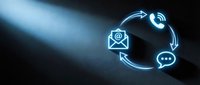 Digital communication icons glowing in blue light showing email, phone and chat symbols connected in circular flow for business contact solutions.