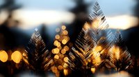 Tropical palm leaves silhouettes against warm golden bokeh lights creating dreamy sunset atmosphere for summer vacation and travel concepts.