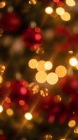 Festive Christmas bokeh lights background with warm golden and red glowing circles creating magical holiday atmosphere for seasonal greeting cards and decorations.