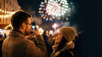 Young couple enjoying fireworks display at night festival with warm lighting and festive atmosphere for celebration events and romantic occasions.