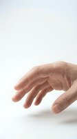 Human hand reaching forward with fingers extended in grasping motion isolated on white background for design projects and presentations.