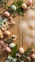 Easter eggs in pastel colors with spring flowers, eucalyptus leaves and ribbons on rustic wooden background with copy space for holiday greeting cards.