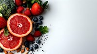 Fresh grapefruit slices, strawberries, blueberries, and broccoli arranged on white background. Healthy food and nutrition concept for wellness, diet, and lifestyle design projects.