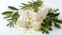 Fresh white cheese with herbs and olive oil on clean background for culinary and cooking projects.