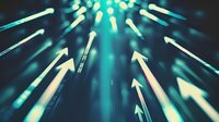 Glowing arrows pointing upward against dark background with turquoise light rays creating dynamic motion effect for business growth and success concepts.