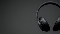Black wireless headphones on dark gray background, isolated for music, audio, technology, and entertainment design projects.
