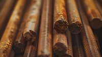 Rusty metal reinforcement bars in diagonal composition showing industrial construction materials with textured corrosion pattern and warm tones.