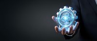 Businessman hand holding glowing gear icon with digital technology interface, representing innovation, engineering, and industrial solutions for business operations.