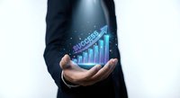 Businessman holding holographic success chart with upward arrow showing business growth and financial progress in corporate environment.