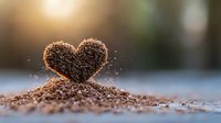 Ground coffee beans arranged in heart shape on wooden surface with soft morning sunlight and bokeh background, romantic coffee concept for cafe and restaurant design.