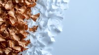 Artistic composition of metallic copper and white textured surfaces creating abstract contrast pattern with organic flowing shapes and dramatic lighting effects.