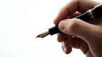 Caucasian male hand holding a black fountain pen with gold accents, ready to write, isolated on white background.