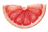 Fresh juicy grapefruit slice with vibrant red flesh and thin peel isolated on white background for food photography, healthy eating concepts.