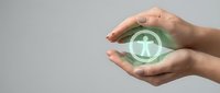 Hands holding glowing green holographic user profile icon with person symbol, representing digital identity protection and cybersecurity solutions.