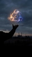 Hand reaching toward glowing geometric light formation in night sky with industrial cityscape background for technology and innovation concepts.