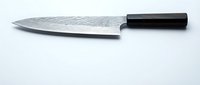 Sharp chef knife with Damascus steel blade and black handle isolated on white background for culinary and kitchen design projects.