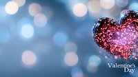 Romantic glowing red heart decoration against blurred blue bokeh background creates dreamy Valentine's Day atmosphere for greeting cards and holiday designs.