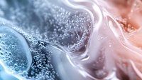 Ethereal abstract fluid art with swirling blue and coral tones creating mesmerizing patterns, sparkling particles and smooth flowing curves against dark background.