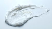 White cream or lotion smear on isolated background, ready for cosmetic, skincare, and beauty product design applications.