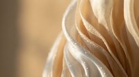 Creamy swirled meringue with soft peaks and delicate texture, perfect for dessert photography and culinary content creation.