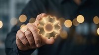 Engineer or technician with light skin tone holding glowing gear symbol, representing industrial innovation, mechanical solutions, and technical expertise for business and technology concepts.