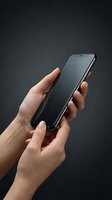 Modern smartphone held in hands against dark gradient background for technology and communication concepts.