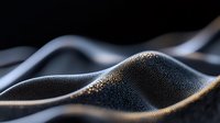 Sensual curves of black sand dunes illuminated by golden sunlight create abstract landscape with dramatic shadows and textures. Macro photography reveals natural patterns.