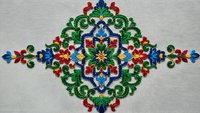 Traditional folk embroidery pattern with colorful floral motifs on linen fabric. Ornate cross-stitch design featuring red, blue, green decorative elements.