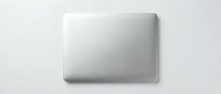 Closed silver laptop top view on white background, isolated for tech, business, and digital design projects.