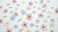 Scattered pastel flowers and leaves on white background, isolated design elements suitable for crafts, invitations, scrapbooking, and decorative projects.