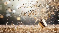 Golden confetti explosion with champagne glass on glittering surface against blurred bokeh background, creating festive celebratory atmosphere.