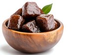 Fresh dates fruit in wooden bowl isolated on white background for healthy snacking and Middle Eastern cuisine recipes.