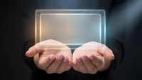 Hands holding glowing neon rectangle frame against dark background, representing digital technology, innovation, and virtual interface for web design and app development projects.