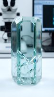 Clear crystal glass award trophy with geometric faceted design in modern laboratory setting for corporate recognition and achievement ceremonies.