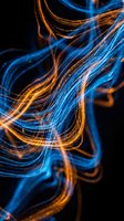 Abstract flowing light trails in vibrant blue and orange hues swirl against a dark background, creating dynamic motion and energy for modern design projects.
