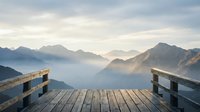 Wooden deck overlooks misty mountain valley at sunrise, offering serene landscape view for travel, nature, and wellness design projects.