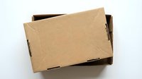 Open brown cardboard shipping box with lid partially removed on white background, perfect for e-commerce packaging and delivery concepts.