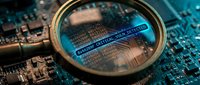 Magnifying glass revealing microchip circuitry and code on blue circuit board, symbolizing technology inspection, cybersecurity analysis, and digital system examination for IT professionals.